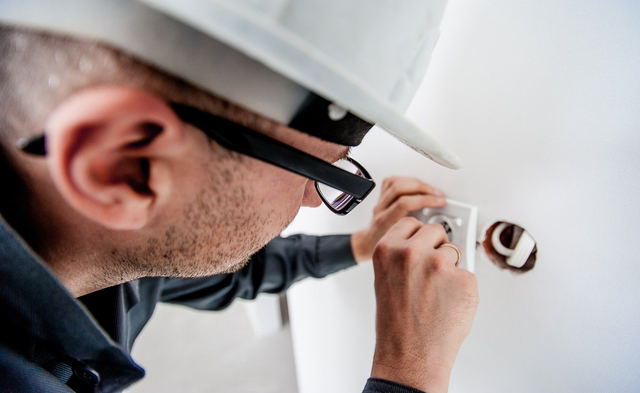 electrician fixing outlet