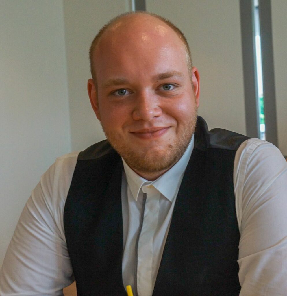 man smiling in tux